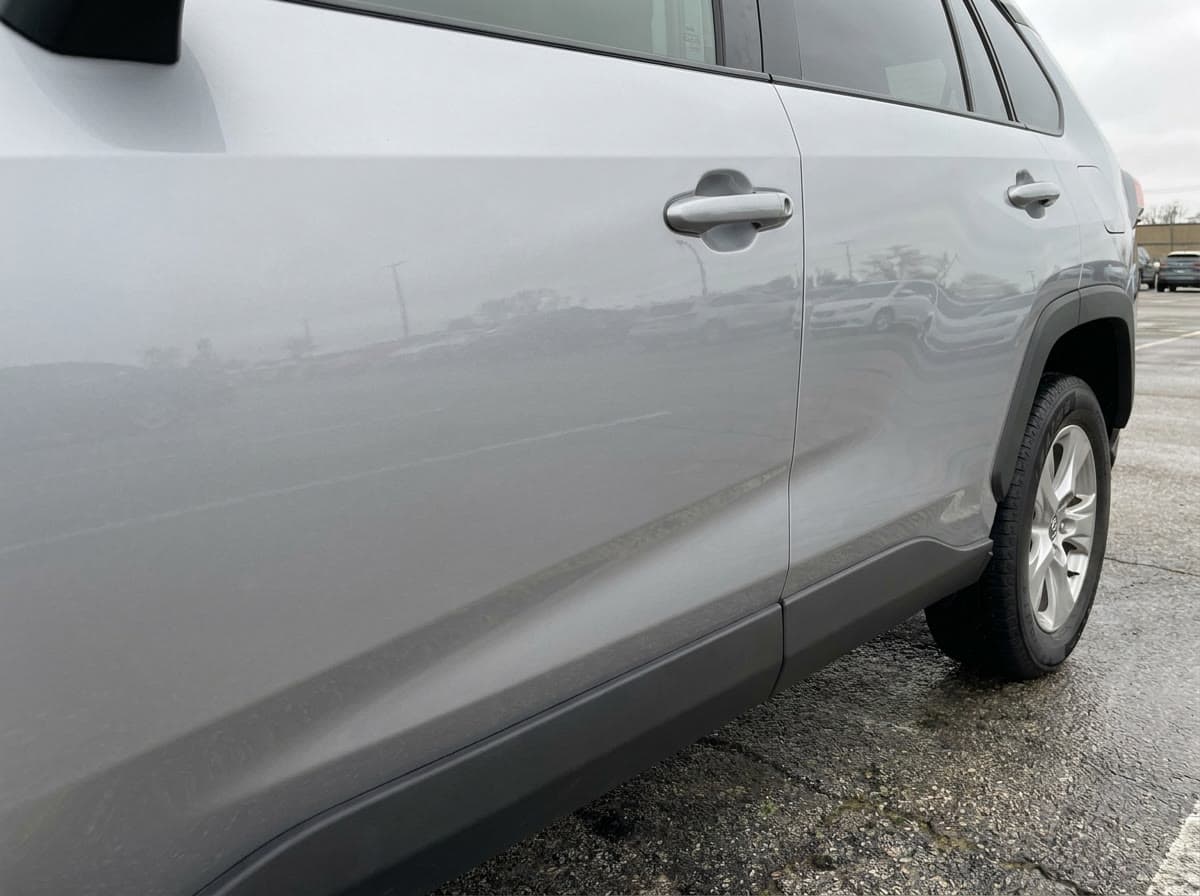 The front driver's door at pickup, undamaged, overcast morning